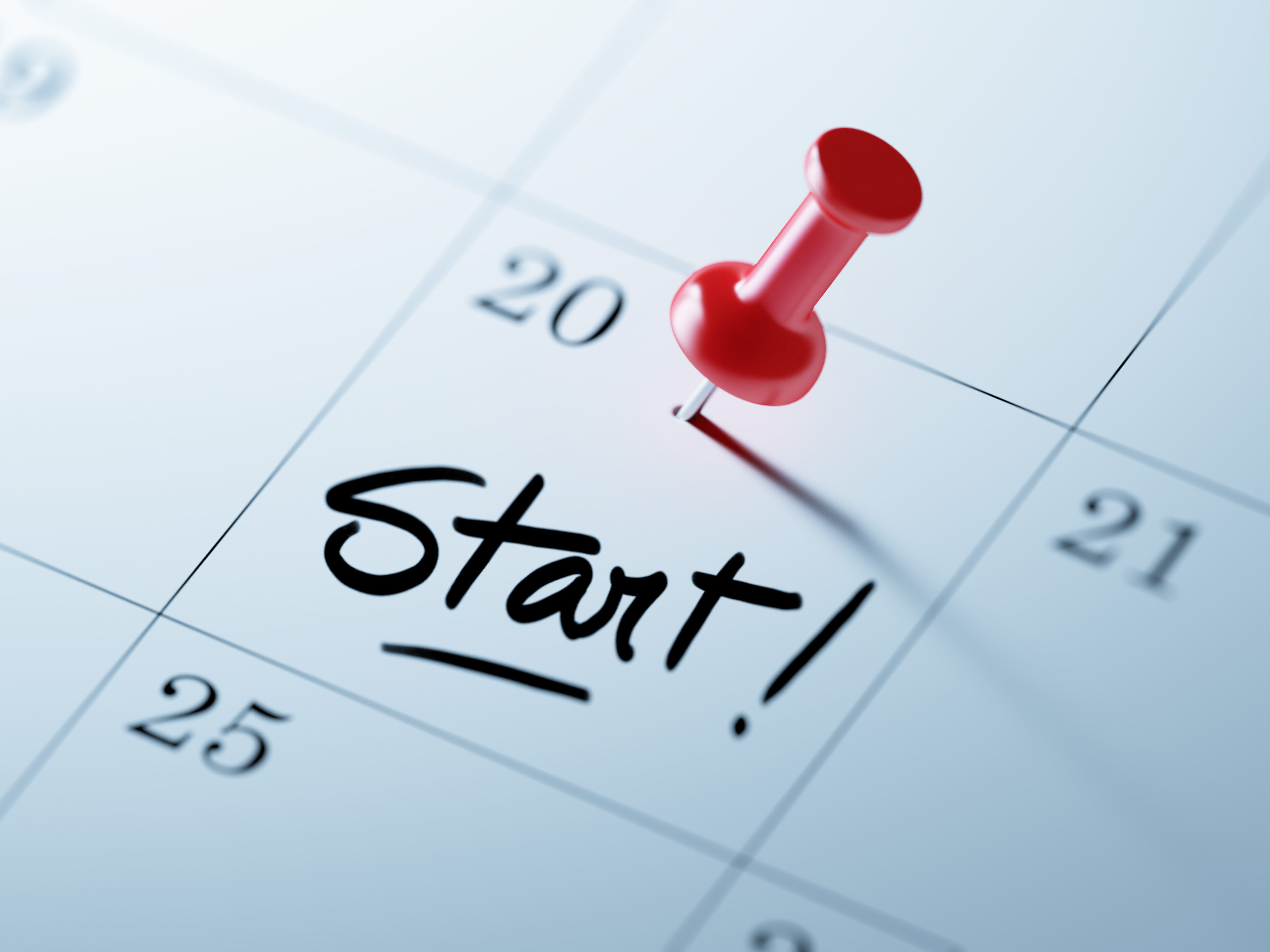 Concept image of a Calendar with a red push pin. Closeup shot of